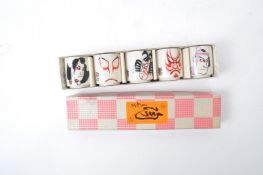 A SET OF FIVE MID CENTURY JAPANESE KABUKI STYLE SAKE CUPS