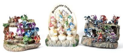 THREE CONTEMPORARY RESIN STANDS HOUSED WITH DRAGON FIGURES
