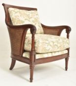 20TH CENTURY WESLEY-BARRELL MAHOGANY AND CANE ARMCHAIR