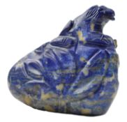 A LAPIZ BOULDER IN FORM OF A LION ON A ROCK 青金石狮子雕刻