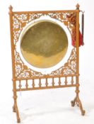 20TH CENTURY BRASS DINNER GONG WITH GILT PAINTED CAST IRON FRAME