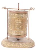 19TH CENTURY TIBETAN BRASS AND COPPER PRAYER WHEEL ON STAND