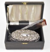 A CASED HALLMARKED SILVER MOUNTED BRUSH AND COMB SET