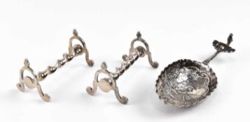 TWO VICTORIAN SILVER KNIFE RESTS AND A CONTINENTAL CADDY SPOON