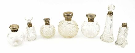 COLLECTION OF SEVEN HALLMARKED SILVER MOUNTED TOP & COLLARED PERFUME BOTTLES