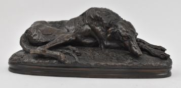 TWO 20TH CENTURY BRONZED RESIN SCULPTURES OF RECLINING DOGS