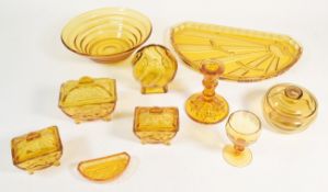 COLLECTION OF MID CENTURY AMBER GLASS DRESSING TABLE SET PIECES