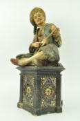 A CERAMIC FIGURINE OF AN MIDDLE EASTERN MUSICIAN
