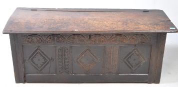 A 17TH CENTURY COUNTRY CARVED OAK COFFER CHEST