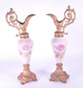 TWO LATE 19TH CENTURY VICTORIAN PORCELAIN AND GILT SPELTER EWERS