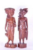 TWO 20TH CENTURY BALINESE CARVED WOODEN FIGURES
