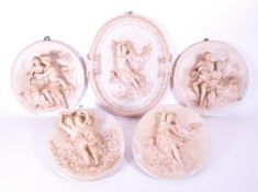 COLLECTION OF FIVE GERMAN BISQUE POTTERY WALL PLAQUES