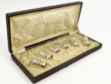 A CASED SET OF SIX 20TH CENTURY SILVER TOT HOLDERS & GLASS CUPS / LIQUOR SET