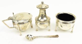 A GEORGE V THREE-PIECE BLUE GLASS LINED HALLMARK SILVER CONDIMENT SET