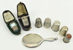 COLLECTION OF SEVEN SILVER THIMBLES & A SILVER MIRROR PENDANT