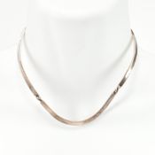 A hallmarked silver torque necklace. The silver torque necklace being twisted on either side and