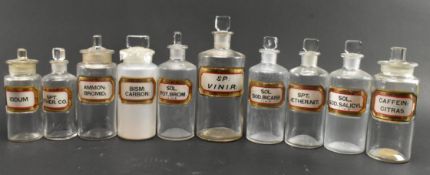 COLLECTION OF TEN EARLY 20TH CENTURY GLASS APOTHECARY / CHEMIST BOTTLES WITH GILT LABELS