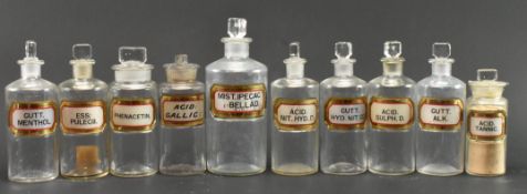 COLLECTION OF ELEVEN EARLY 20TH CENTURY GLASS APOTHECARY / CHEMIST BOTTLES WITH GILT LABELS