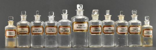 COLLECTION OF ELEVEN EARLY 20TH CENTURY GLASS APOTHECARY / CHEMIST BOTTLES WITH GILT LABELS