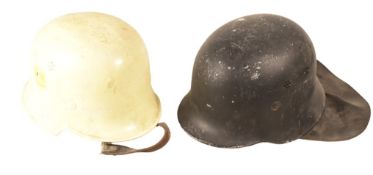 TWO POST SECOND WORLD WAR GERMAN FIRE HELMETS