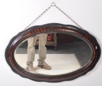 EARLY 20TH CENTURY OVAL MAHOGANY WALL MIRROR