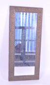 20TH CENTURY REPOUSSE DECORATED METAL FRAMED MIRROR