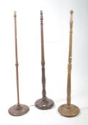 THREE 20TH CENTURY MAHOGANY AND OAK STANDARD FLOOR LAMPS