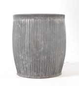 A VINTAGE GALVANIZED STEEL BARREL PLANTER DOLLY