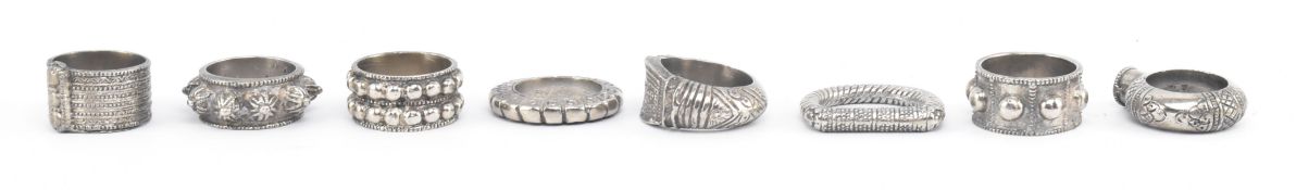 COLLECTION OF EIGHT ARABIC SILVER WHITE METAL NAPKIN RINGS