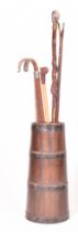 20TH CENTURY COPPERED OAK BARREL STICK STAND COMPLETE WITH WALKING STICKS