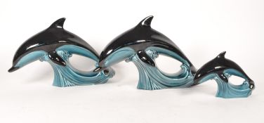 POOLE POTTERY - THREE LATE 20TH CENTURY GRADUATING DOLPHINS