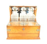 ARTS AND CRAFTS STYLE TANTALUS WITH THREE CUT CRYSTAL DECANTERS