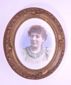 1956 PAINTED PHOTOGRAPH OF A PORTRAIT OF A LADY IN OVAL GILT FRAME