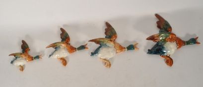 BESWICK - FOUR MID CENTURY CERAMIC GRADUATING DUCK WALL PLAQUES