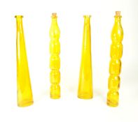 FOUR MID 20TH CENTURY AMBER GLASS BOTTLES