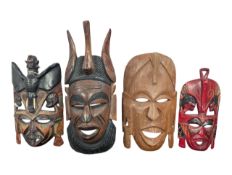TRIBAL ART - FOUR 20TH CENTURY CARVED HARDWOOD AFRICAN MASKS