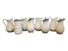 EIGHT 19TH CENTURY VICTORIAN CERAMIC RELIEF MOULDED PARIAN WARE WHITE JUGS