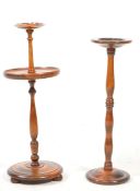 TWO EARLY 20TH CENTURY TURNED MAHOGANY FLOOR STANDING ASHTRAYS
