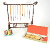 CHINESE ART MATERIALS INCL HANGING BRUSH DISPLAY STAND, BRUSHES, INKS