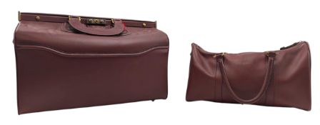 LES MUST DE CARTIER - TWO VINTAGE MAROON LEATHER TRAVEL BAGS