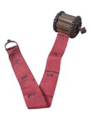 20TH CENTURY TIBETAN CARVED WOODEN AND FABRIC MEASURING TAPE
