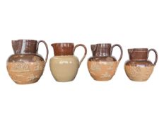 FOUR EARLY 20TH CENTURY STONEWARE HARVESTWARE GRADUATING JUGS