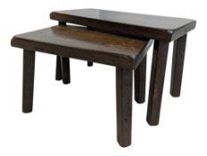 PAIR OF 20TH CENTURY ARTS & CRAFTS DARK OAK NESTING TABLES