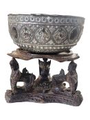 19TH CENTURY BURMESE SILVER PLATED THABEIK BOWL ON A CARVED WOODEN STAND