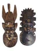 TWO AFRICAN TRIBAL MID CENTURY HAND CARVED WALL HANGING MASKS