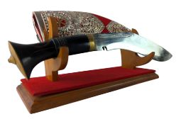 A LARGE DECORATIVE KUKRI KNIFE ON STAND