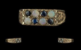 Ladies 9ct Gold Pleasing Sapphire and Opal Set Ring with raised, open worked setting, full