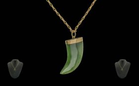 A Pleasing 9ct Gold Mounted Jade Pendant In The Form of An Animals Tooth with Attached 9ct Gold
