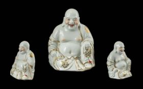 Modern Buddha Figure, seated smiling Buddha in white with gilt decoration. Measures 9'' high x 7''