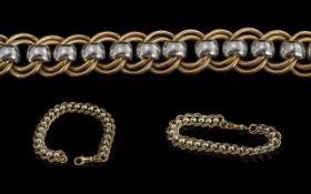 A Fine Quality 9ct Two Tone Gold Roll-a-ball Design Bracelet. With Gold Marks for 9ct. Pleasing